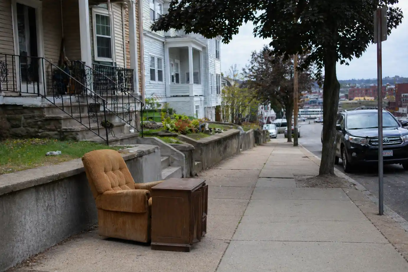 Old furniture placed on curb for bulk trash pickup in New Bedford neighborhood